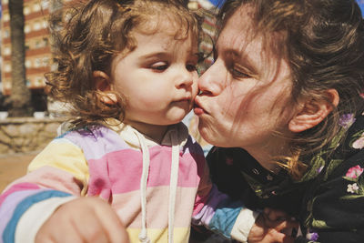 Close-up of young woman blowing bubbles