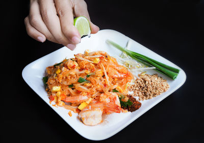 Close-up of person holding food in plate