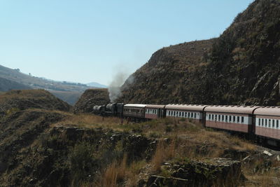 Train on mountain against clear sky