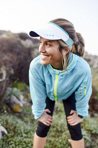 Smiling woman taking break after running