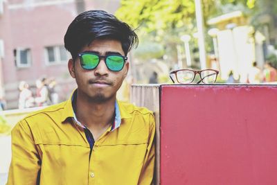 Portrait of teenage boy wearing sunglasses standing outdoors