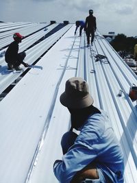 Construction workers working on roof 