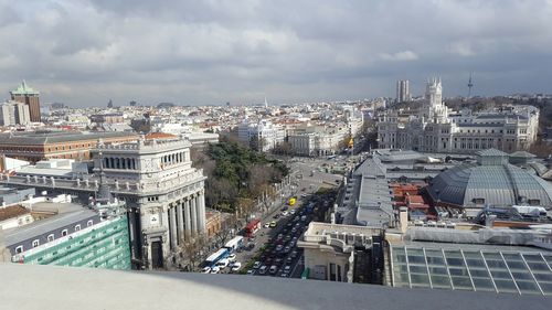 High angle view of city street against cloudy sky