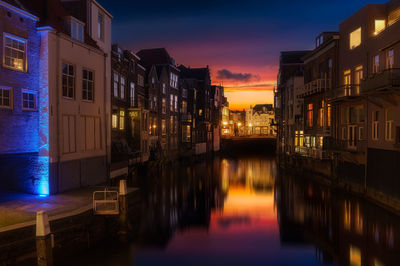 Canal in city at night