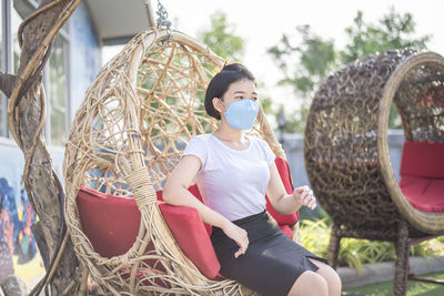 Asian girl wearing a mask detained and happy at home ,stay home away from society, new normal.