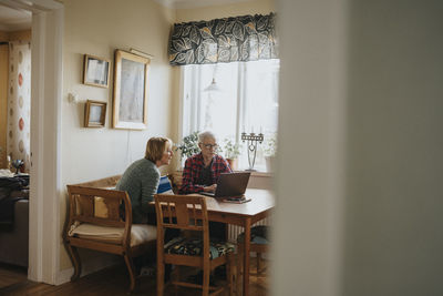 Senior couple using laptop at home