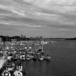 High angle view of boats moored at lake in city against sky