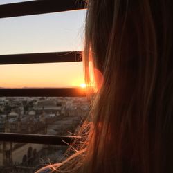 Close-up portrait of cityscape against sky during sunset