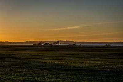 Scenic view of field against sky during sunset