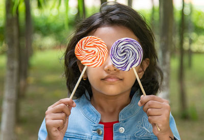 Portrait of a girl holding multicolored  candy