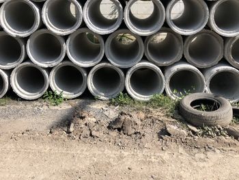 Stack of pipes on field