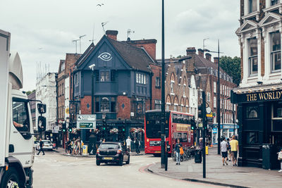 Vehicles on road by buildings in city