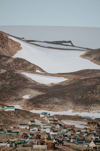 Houses on snow covered mountain