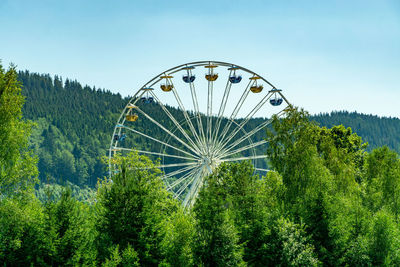 Low angle view of ferris wheel against sky