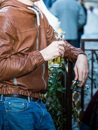 Rear view of man holding drink