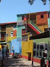 Man outside house against clear sky