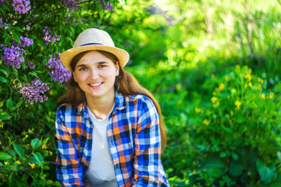 Spring person. defocus beautiful young woman near blooming spring tree. bush lilac flowers. youth