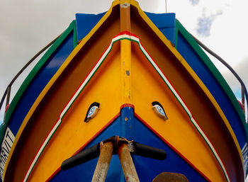 Low angle view of yellow ship against sky