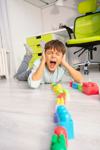 Portrait of boy playing with toys on floor