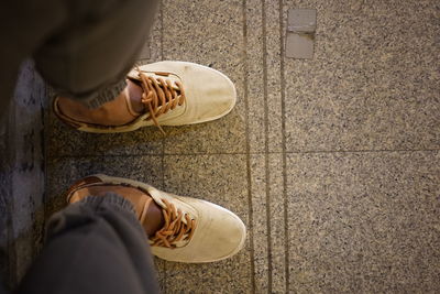 Low section of person on tiled floor