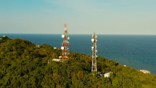 Telecommunication tower, communication antenna in tropical island. repeaters on a metal tower.