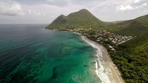 Scenic view of sea and mountains against sky