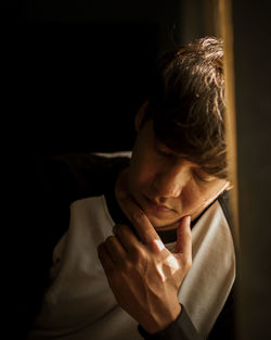 Close-up of young man in dark