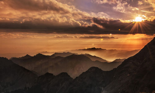 Scenic view of silhouette mountains against sky during sunset