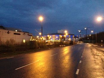 Illuminated city street at night