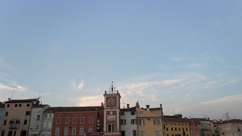 Low angle view of buildings in town against sky