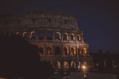 Low angle view of illuminated building against sky at night