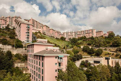 Low angle view of buildings against cloudy sky