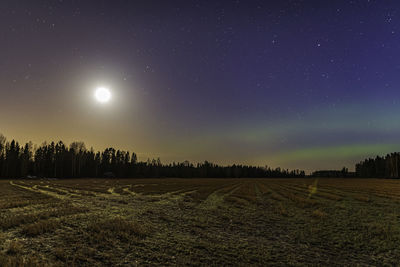 Scenic view of field against sky at night