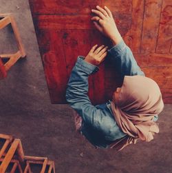 High angle view of woman sitting on floor