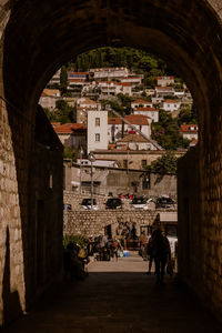 People on street amidst buildings in city