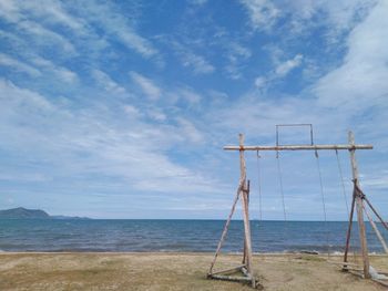 Lifeguard hut on beach against blue sky