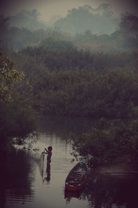 Scenic view of lake with trees in background