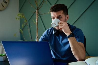 Surprised man looking at laptop screen