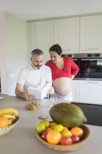 Man and vegetables in kitchen at home