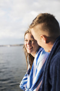 Portrait of smiling man and woman in water