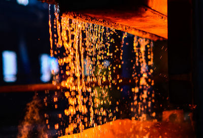 Light trails on illuminated building at night