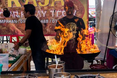 Midsection of man standing at market stall