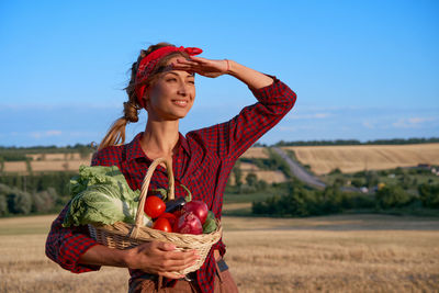 Full length of woman in basket on field against sky