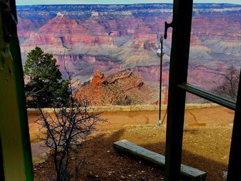 Scenic view of mountains seen through glass window