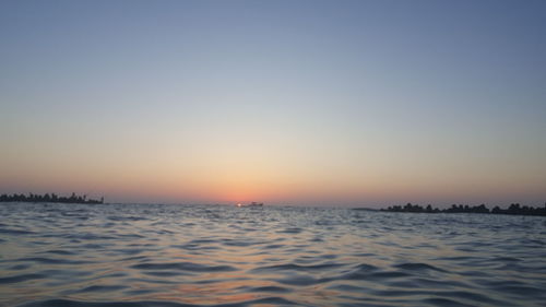 Scenic view of sea against clear sky during sunset