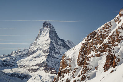 Scenic view of snowcapped mountains against clear sky