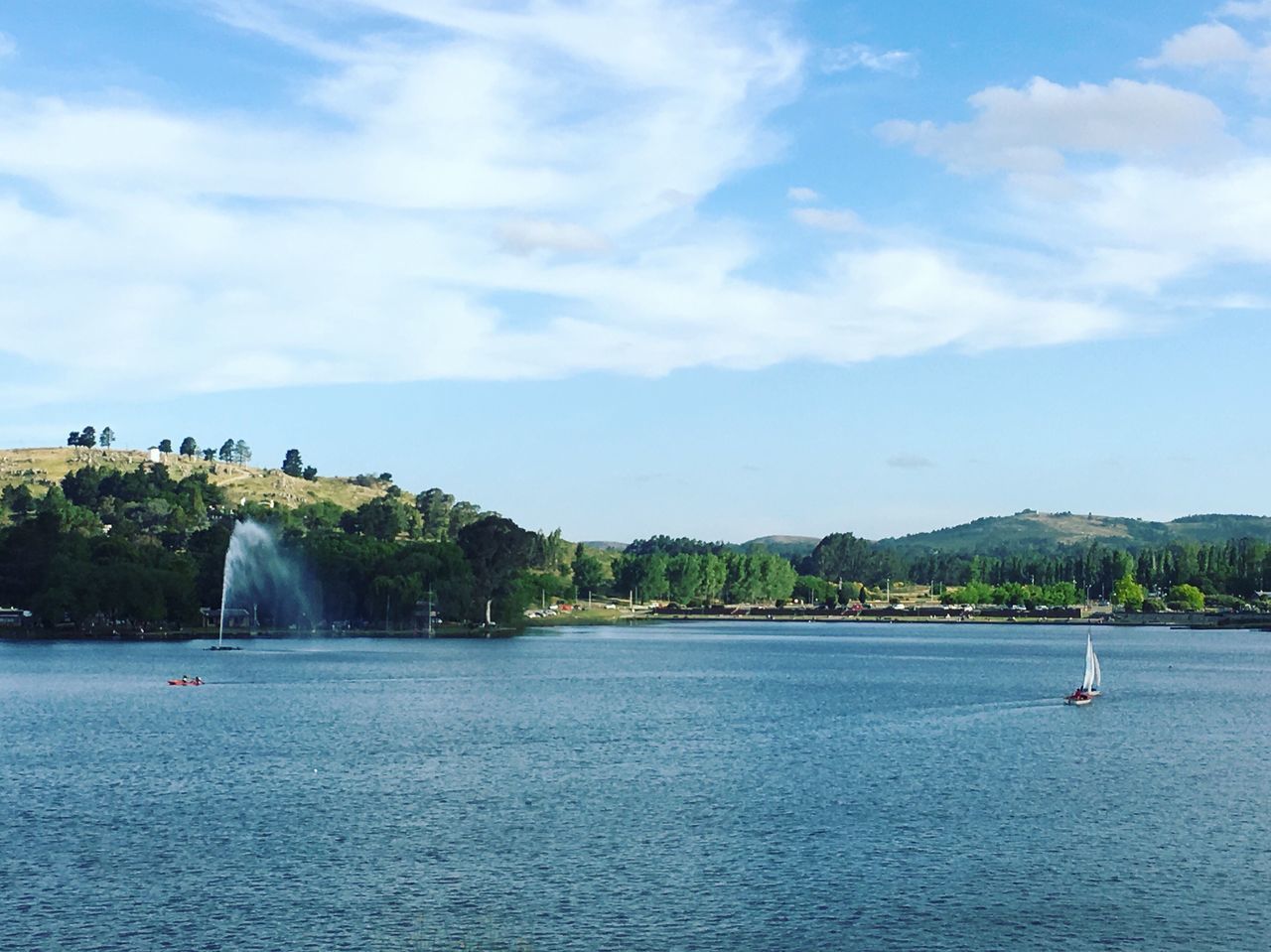 water, tree, sky, cloud - sky, nature, day, beauty in nature, outdoors, scenics, travel destinations, growth, lake, fountain, tranquil scene, nautical vessel, no people, mountain, architecture