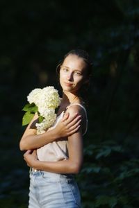 Portrait of a woman holding flower bouquet