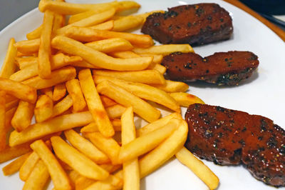 Close-up of burger and fries on plate