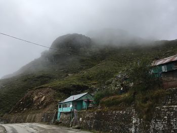 Scenic view of mountains and buildings against sky